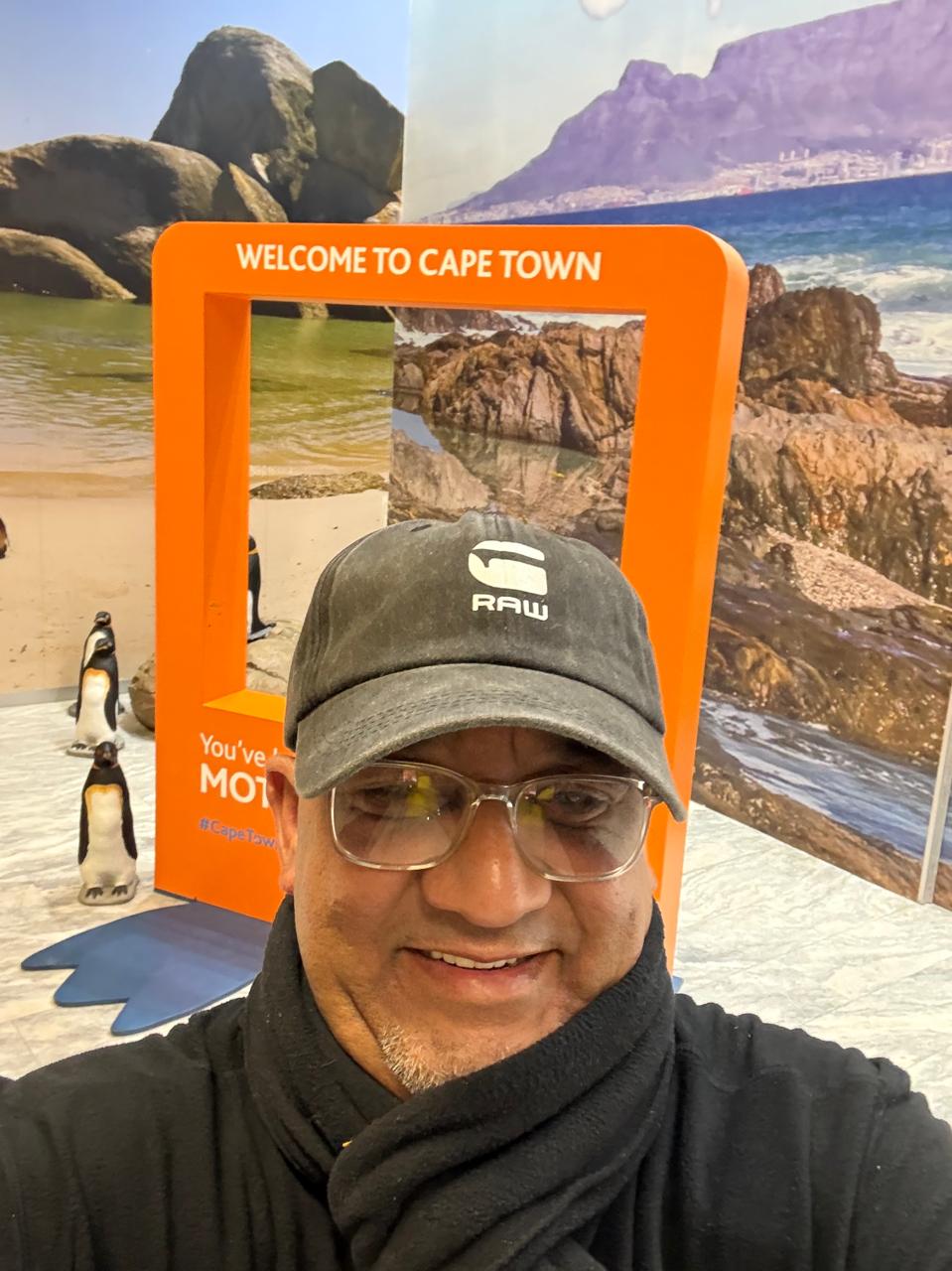 Harry Juries with an i-Drive welcome sign for arriving guests