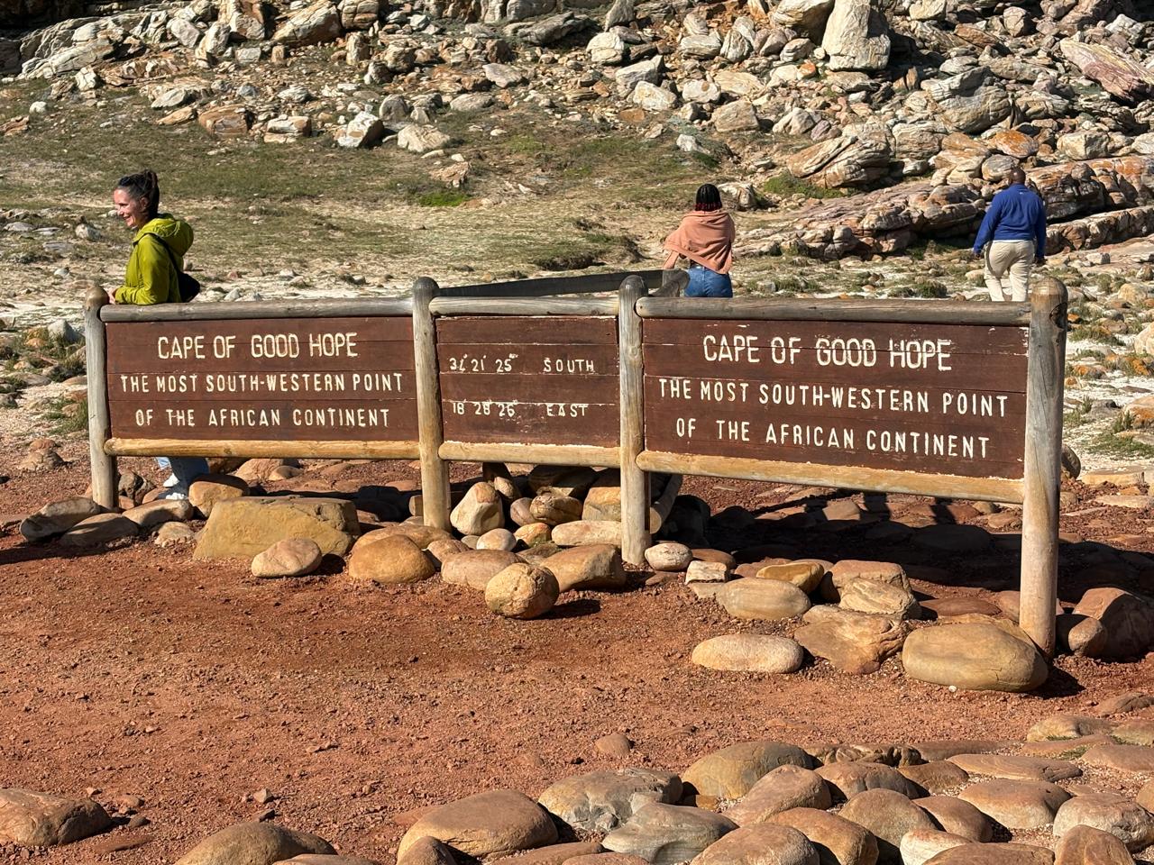 Clients at the Cape of Good Hope sign