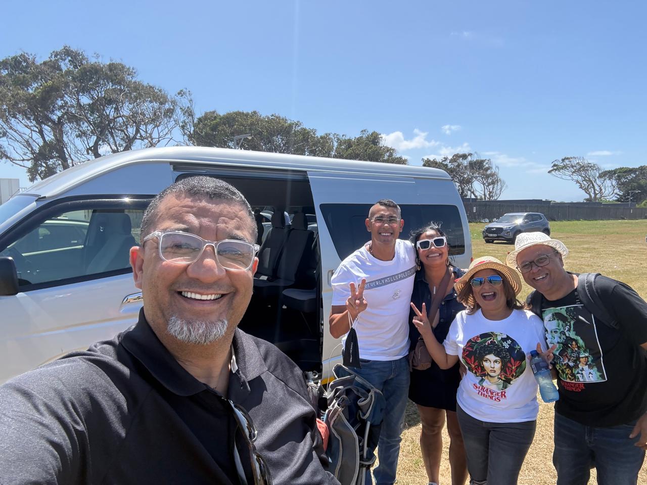 Happy clients with their i-Drive minibus on a Cape Town road trip